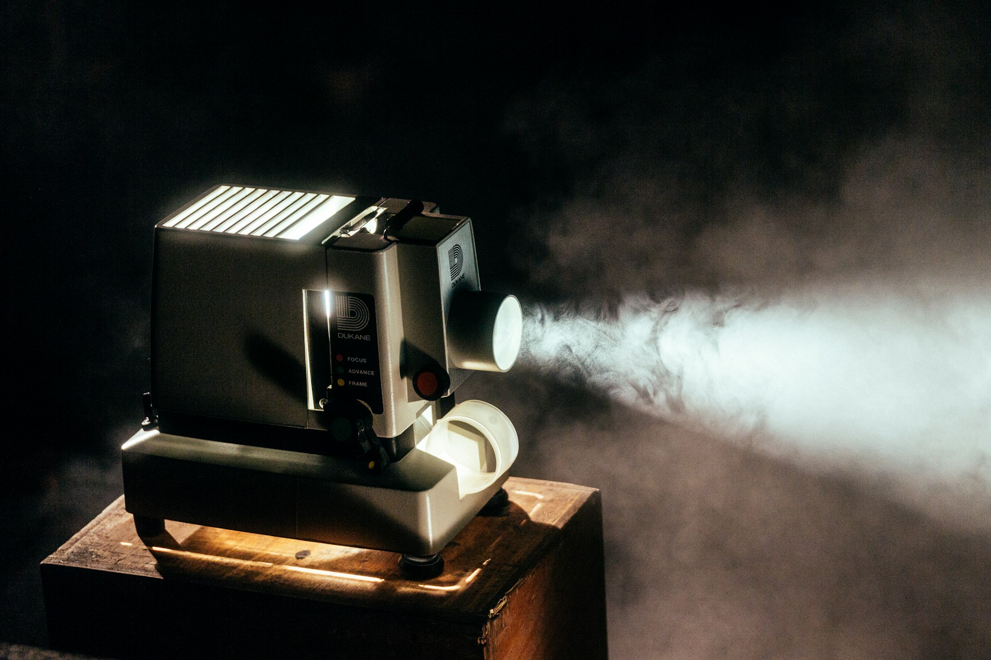 Vintage film projector with beam in a dark room